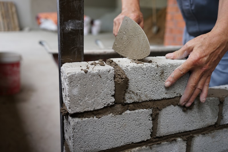 Render being worked onto brickwork