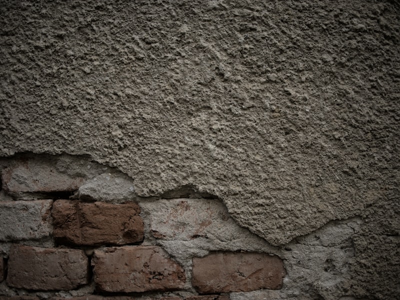 Render stripped back to the brick beneath